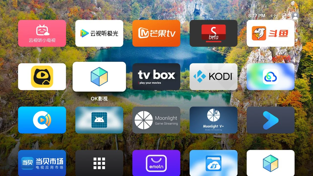Capture réelle de la grille de toutes les apps : plusieurs rangées d'icônes 16:9 sur le fond d'écran.